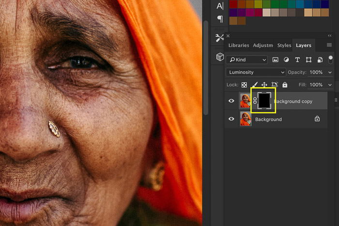 A screenshot showing how to sharpen an image in Photoshop using a portrait of an Indian woman