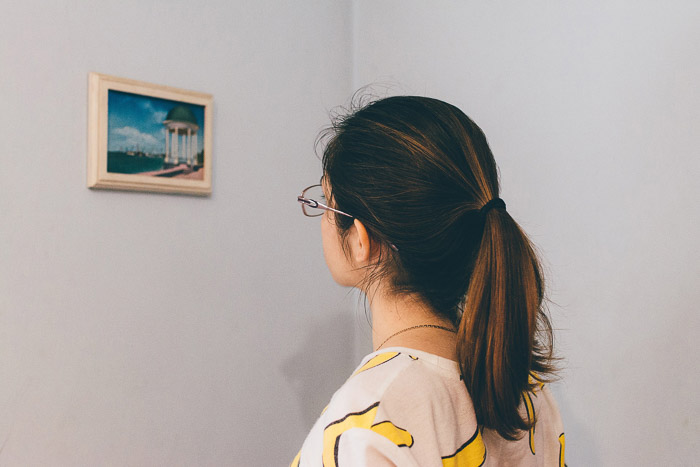 A girl looking at a painting in a gallery - How to Use Smart Objects in Photoshop